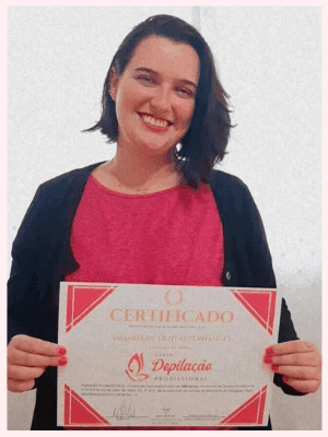 Uma mulher mostrando seu certificado de conclusão do curso de profissionalização. Ela está feliz